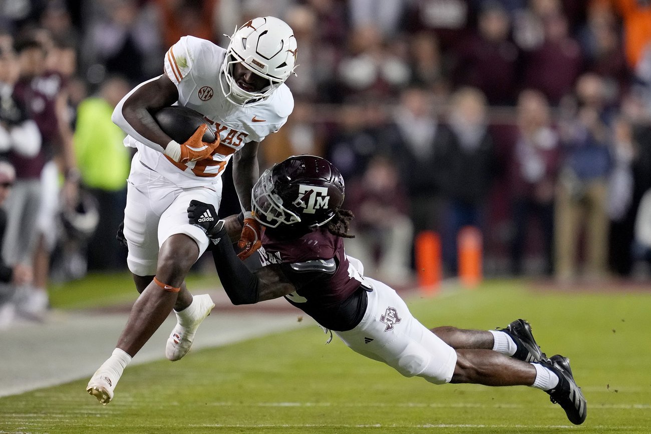 Texas running back Quintrevion Wisner (26) is tackled by Texas A&M defensive back Will Lee III (26) after a catch and run during the first quarter of an NCAA college football game
