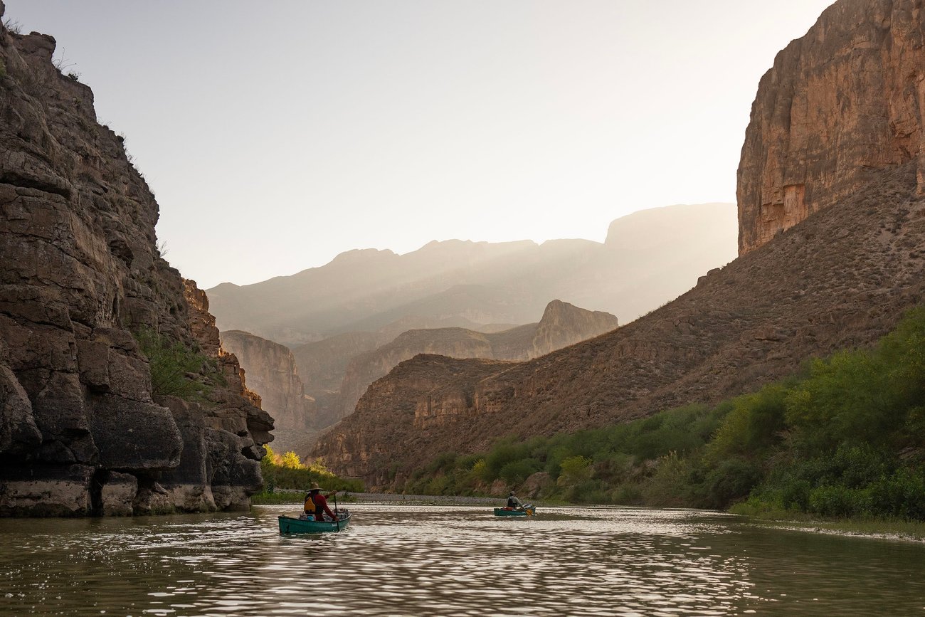 Todd Grier, left, and Mark Fluker, right, of Texas A&M Outdoor Adventures paddle down the Rio Grande River inside of Boquillas Canyon in Big Bend National Park